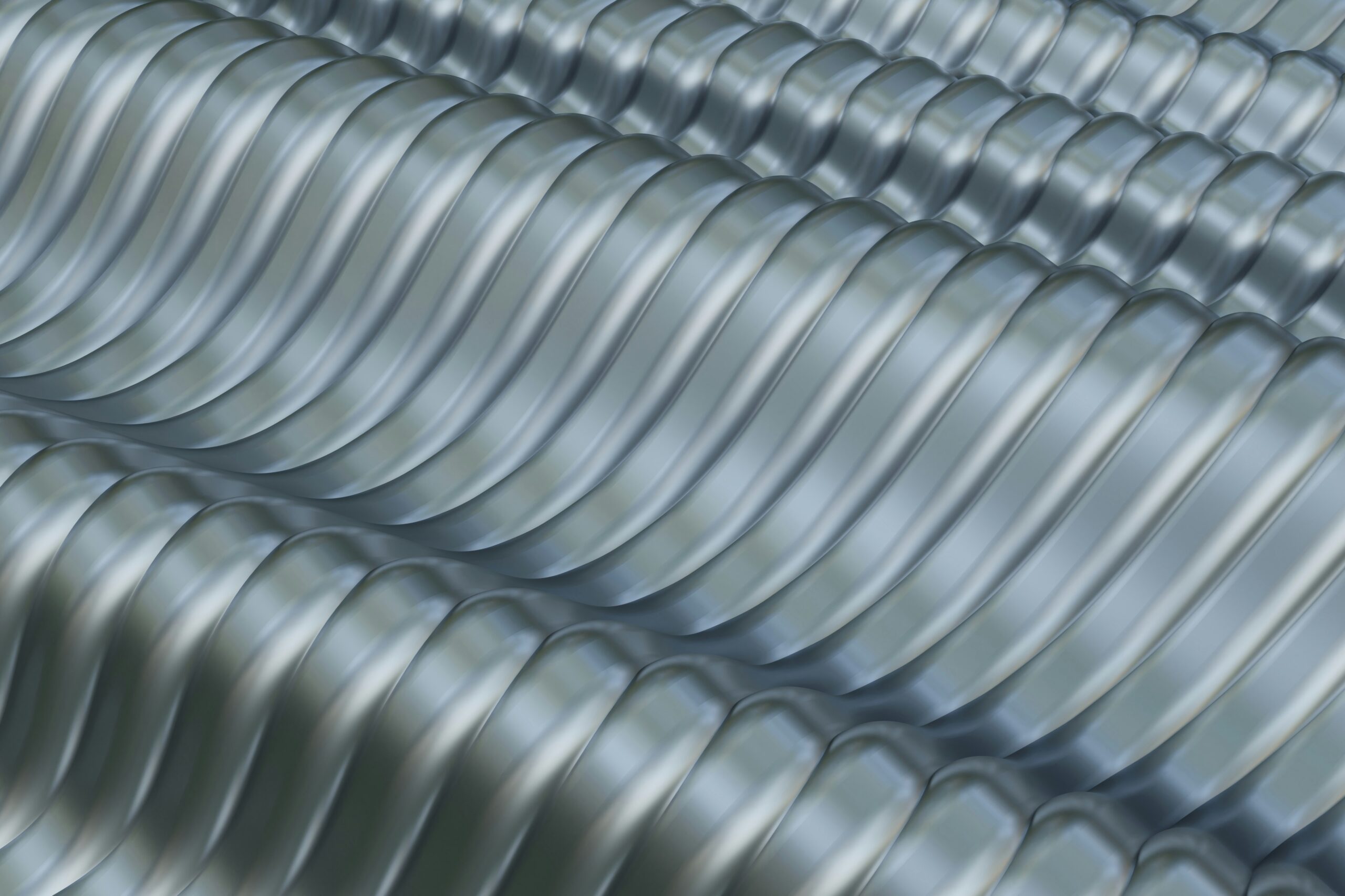 Close-up image of several parallel rows of shiny, silver, corrugated aluminium sheets arranged in a wavelike pattern. The reflections on the surface emphasize the texture and curvature of the metal, highlighting its sustainable qualities that align with environmental claims.