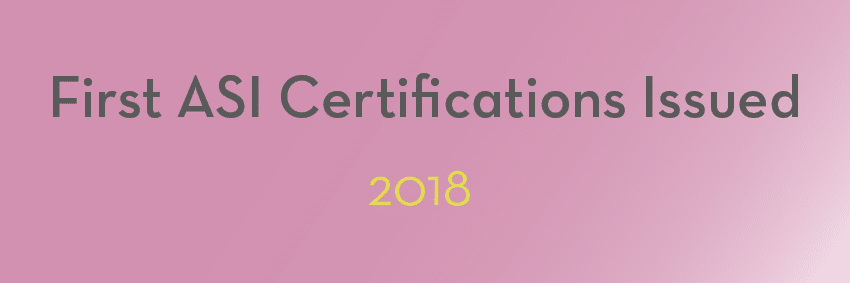 Image with a pink background displaying the text "First ASI Certifications Issued" in dark gray and "2018" in yellow, capturing a significant moment in the aluminium industry.